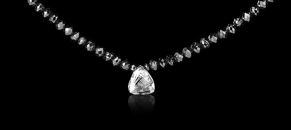2.67 ct. Natural Rough diamond & 26.64 ct. Black Facetted diamonds in a collier