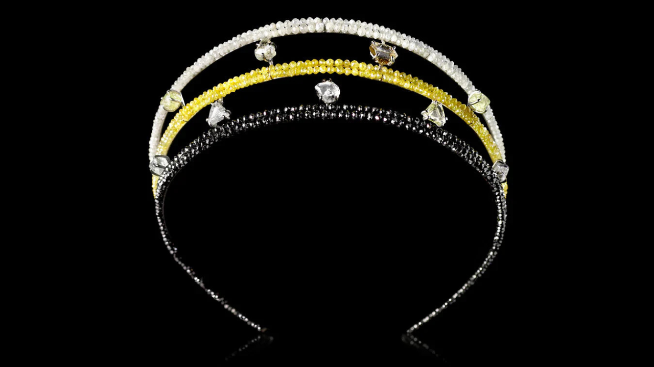 Three-layered tiara with colored stones on a black background