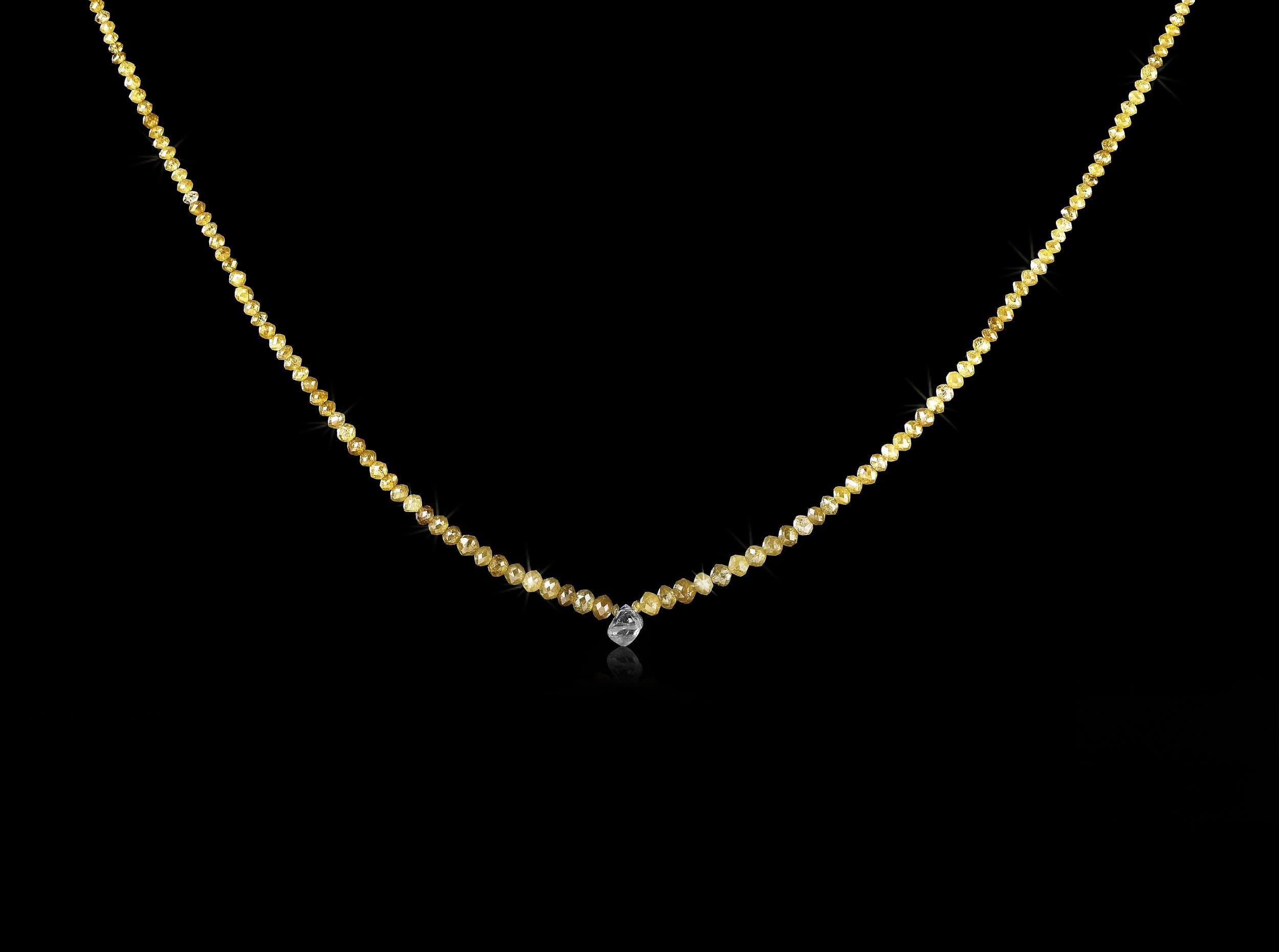 1.13 ct. Natural Rough diamond & 20.09 ct. Yellow Facetted diamonds in a collier